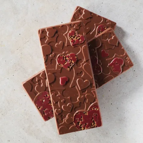 Chocolate bars made with Valrhona Amatika 46% plant-based chocolate, decorated with red hearts
